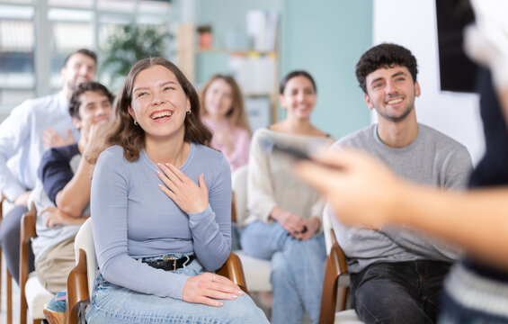 Guys and girls giggle and smile, offline intensive and coaching. Language conversation speaking club, team building, professional development courses, educational seminar.