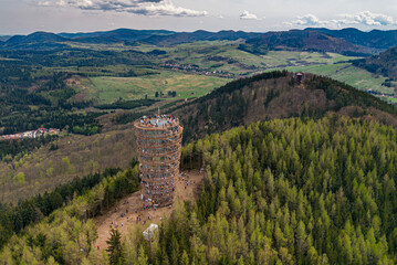 Aerial view of observation tower on Dzikowiec Mountain surrounded by forest	