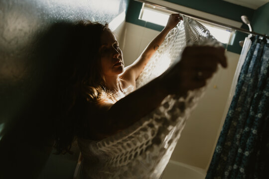 Woman holding up skirt with polka dots