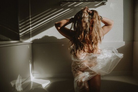 Woman with hands in hair in bubble wrap