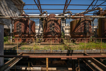 Fototapeta premium Derelict industrial hall of an abandoned Italian sugar mill. Large warehouse ruins with decaying walls and urban exploration atmosphere
