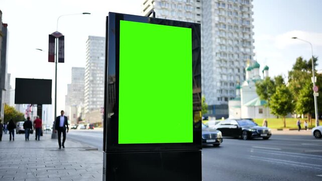 Green screen advertising billboard mockup on a city street with traffic and buildings
