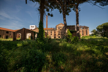 Abandoned sugar factory interior in Italy. Industrial urbex photography of derelict refinery ruins with rusted machinery and old architecture
