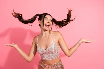Fotobehang Diamanten Joyful fashionable young woman with pink background wearing sequined top and skirt smiling with pigtails ready for party fashion lifestyle shoot  © deagreez