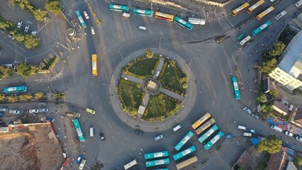 Aerial top down view of a busy roundabout with colorful buses, Addis Ababa, Ethiopia © yannis
