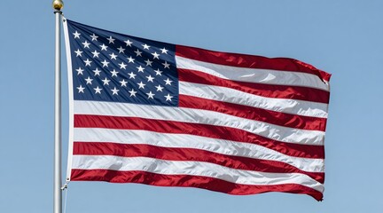 American flag waves in the wind against a clear blue sky on a sunny day