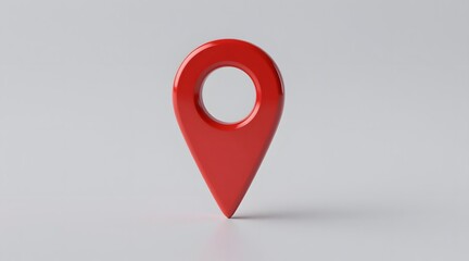 Shiny red location pin stands upright on a white surface in a simple studio shot