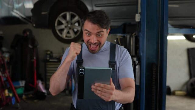 Mechanic celebrates success while checking car repairs in garage