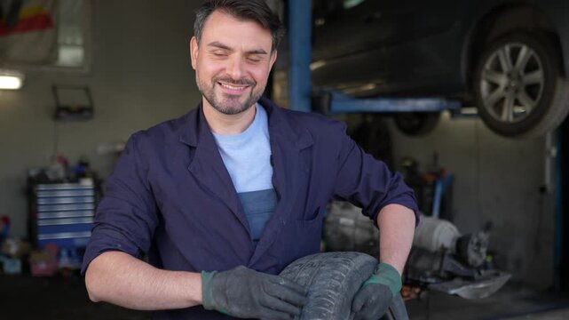 Mechanic repairs tire in garage during afternoon