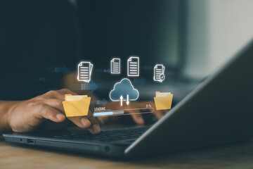 Cloud computing concept. Man working file transfer data synchronization on laptop. Digital document management system, cloud storage, data backup, online sharing, modern business technology workflow.