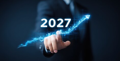 businessman holding a virtual 2027 graph with an arrow pointing up