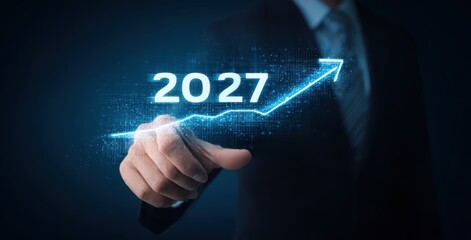 businessman holding a virtual 2027 graph with an arrow pointing up