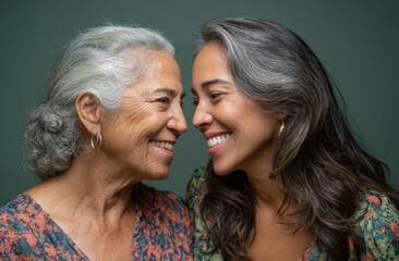 Happy elderly mother and adult daughter share a touching moment and smile at each other, mother's day.