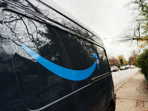 Amazon delivery van on a Manchester street with blue smile logo in autumn weather
