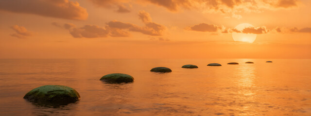 A serene sunset scene over calm waters featuring vibrant hues, green pebbles, and fluffy orange clouds.