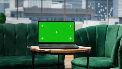 Empty global corporation office showcasing a green screen on laptop, modern workspace equipped with...