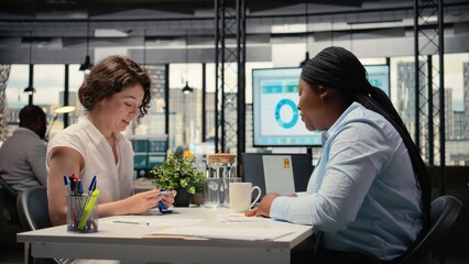 HR employee offers access key card to new hire after the interview, finalizing the onboarding process and registration after resume and CV approval. Welcoming to the team. Camera A.