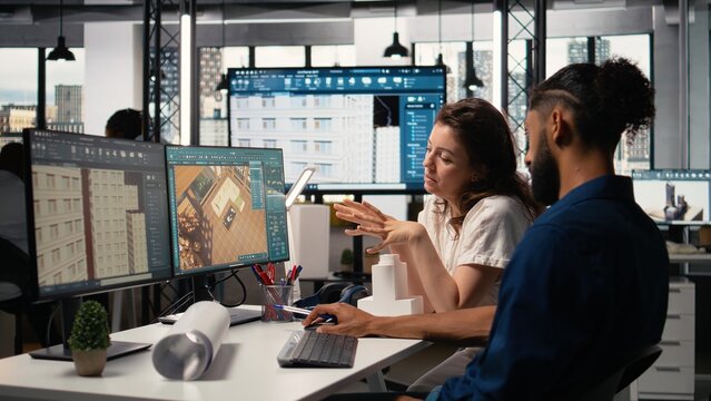 Engineer and property developer working with architectural design software, analyzing project layouts and renovation strategies for real estate expansion and urban development.