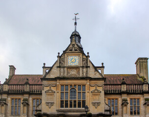 Beautiful blue clock with gold elements on the roof of the building.