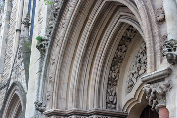 Wesley Memorial Church, a Methodist church in central Oxford. Tympanum above the entrance, decorated with stone carvings. Oxford, United Kingdom.