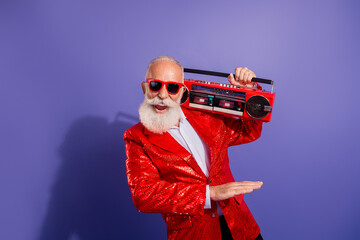 Elegant retro showman with a red sequined jacket and boombox posing for a festive party shot