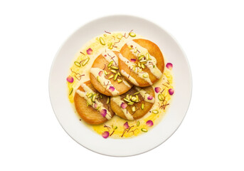 pistachio cookies with saffron drizzle and flower petals on plate
