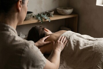 Expert therapist delivers a rejuvenating back massage in a tranquil spa environment