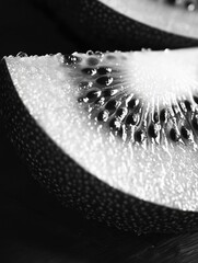 A vibrant and appetizing depiction of a sliced kiwi with droplets of water on its surface. A high-resolution image that captures the textures and colors of this nutritious fruit in detail.