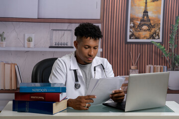 A healthcare professional focused on reviewing documents in their office.