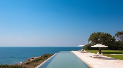 Relaxing by the ocean with a pool and sun loungers on a sunny day