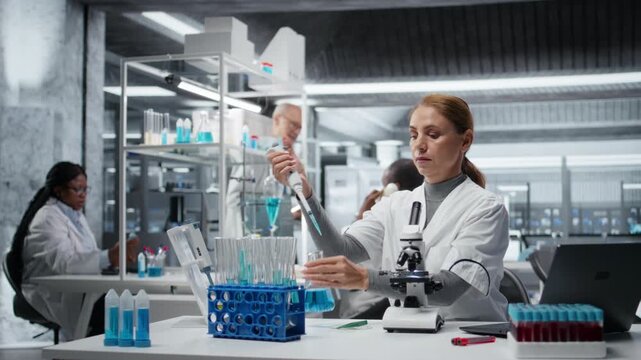 Researcher pipetting reactant into blue solution for purity analysis. Female cytotechnologist adding liquid agent to test tube to observe chemical reaction properties, camera A