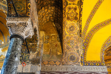 Ancient byzantine mosaics and intricate column in historic church interior