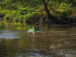 Paddling On Shaded River Down Stream