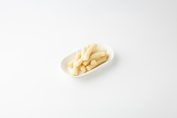 Plain Korean Rice Cakes on White Plate Isolated on White Background 흰 접시에 담긴 떡볶이용 가래떡