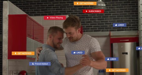 Dancing two men embracing in kitchen wearing denim shirt, patterned T-shirt, red cabinets, overlays