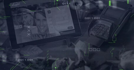 Showing tablet on stand displaying dating app at checkout among plants, card reader and binary code
