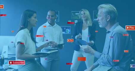 Discussing team of four in smart dress reviewing displays in office, with tablet and overlay icons