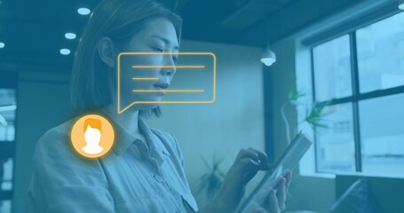 Holding woman in light button shirt tapping tablet in office lounge, with chat bubble avatar icon
