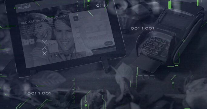 Showing tablet on stand displaying dating app at checkout among plants, card reader and binary code