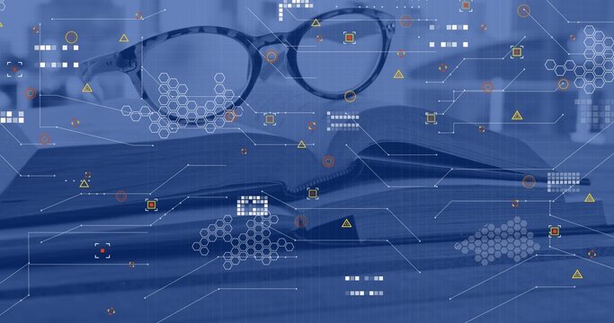 Resting round eyeglasses sitting on open printed book at desk, with hexagon HUD graphics overlay