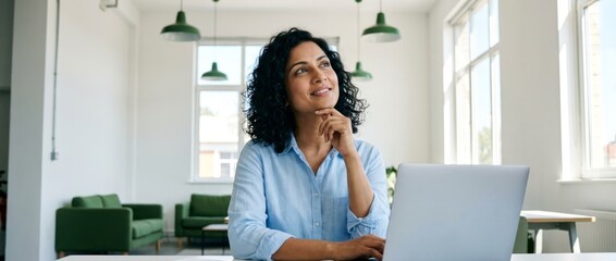 Reflective Businesswoman Engaged in Work at Modern Office Space