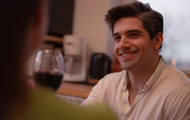 Portrait of a happy man having a conversation with his girlfriend during a romantic date night....