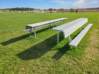 Soccer field bleachers. Empty aluminum bleachers beside a soccer field