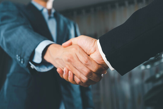 Business people agreement concept. Businessman do handshake with another businessman in the office meeting room. uds
