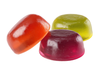 Three gelatinous translucent lozenges stacked on a dark background