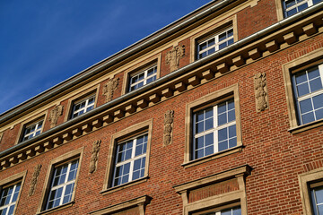 Fototapeta premium Detail of the red brick architecture of the former ThyssenKrupp administrative building in Ehrenfeld, Cologne, featuring neoclassical ornaments
