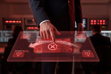 Businessman touching red holographic critical error warning on virtual screen in dark server room