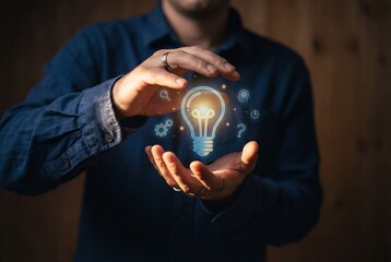 Man holding hands around glowing lightbulb icon representing creative business innovation