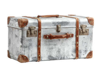 Aged metal trunk with leather straps and hardware, set against a black backdrop