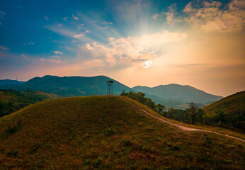 A watch tower on a beautiful sunset sky with clouds